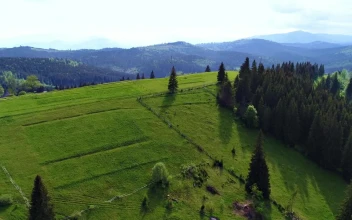Stock Video Field Of A Farm With A View Of The Mountains For PC