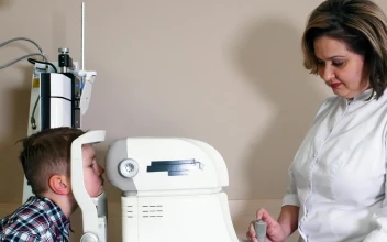 Stock Video Female Ophthalmologist Doing An Eye Exam To A Child For PC