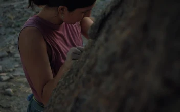 Stock Video Female Mountaineer Climbing Up A Rocky Hill For PC