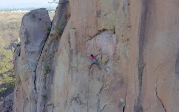 Stock Video Female Mountaineer Climbing On Top Of A Mountain For PC