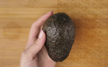 Stock Video Female Hands Cutting An Avocado In The Kitchen For PC
