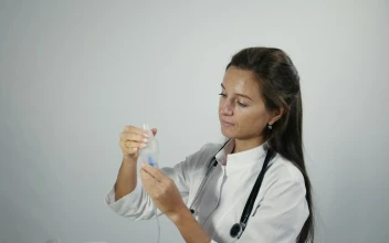 Stock Video Female Doctor Testing An Inhaler For PC