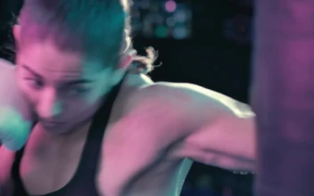 Stock Video Female Boxer Training With A Punching Bag For PC