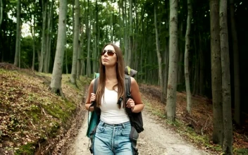 Stock Video Female Backpacker Touring A Forest For PC