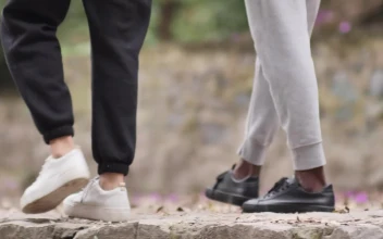 Stock Video Feet Of A Couple Of People Walking In A Park For PC