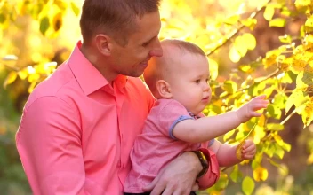 Stock Video Father Taking Care Of His Baby In A Garden For PC