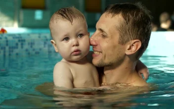 Stock Video Father Hugging His Son In The Pool For PC