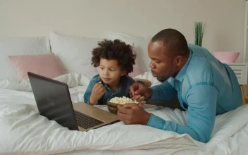 Stock Video Father And Son Watching A Movie For PC