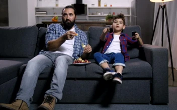 Stock Video Father And Son Watching A Film For PC