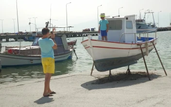 Stock Video Father And Son In A Small Harbor For PC