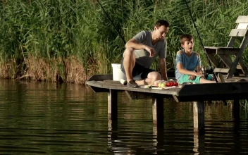 Stock Video Father And Son Having Lunch While Fishing For PC