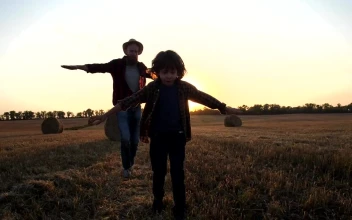 Stock Video Father And Son Flying Through A Field For PC