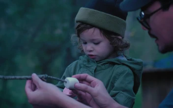 Stock Video Father And Daughter Placing Marshmallows On A Branch Outdoors For PC