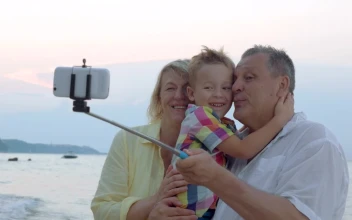 Stock Video Family Taking A Photo With A Selfie Stick For PC