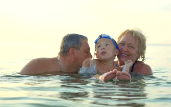 Stock Video Family Standing In The Ocean For PC