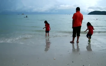 Stock Video Family Standing In Shallow Waves For PC