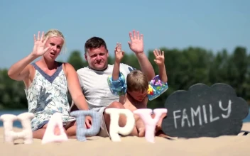 Stock Video Family Sitting Together On The Beach For PC