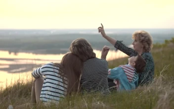 Stock Video Family Sitting On A Hill Watching The Nature For PC