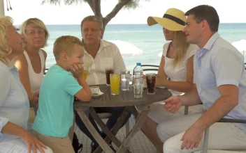Stock Video Family Sitting At A Beach Table For PC