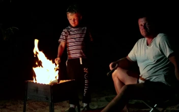 Stock Video Family Resting By A Campfire For PC