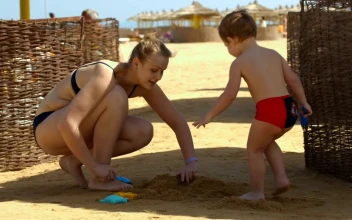 Stock Video Family Playing On The Beach During A Vacation For PC