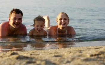 Stock Video Family Laughing While Laying In The Ocean For PC
