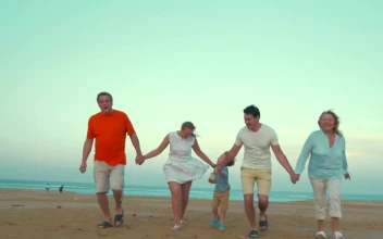 Stock Video Family Holding Hands At The Beach For PC
