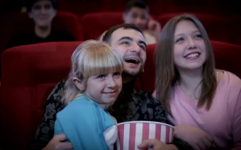 Stock Video Family Enjoying A Movie At The Cinema For PC