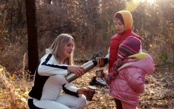 Stock Video Family Drinking Tea In An Autumn Forest For PC