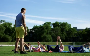 Stock Video Family Doing Exercise Together In The Park For PC