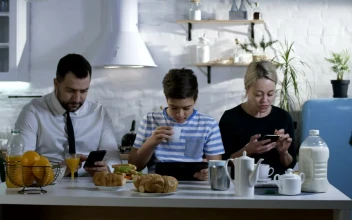 Stock Video Family At Breakfast Watching Their Smartphones For PC
