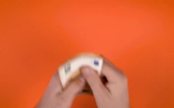Stock Video Hands Full Of Money On An Orange Background For PC