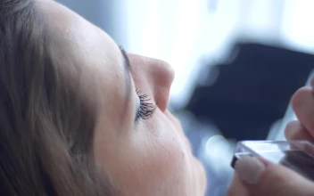 Stock Video Hands Applying Lashes On A Model For PC