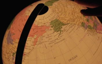 Stock Video Hand Turning A Luminous Earth Globe In The Dark For PC