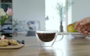 Stock Video Hand Takes Cup Of Coffee From The Table For PC