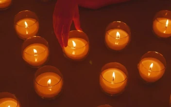 Stock Video Hand Of A Lady Arranging Burning Candles For PC