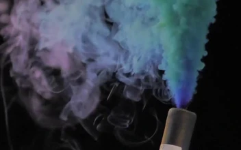 Stock Video Hand Holding A Multicolored Smoke Bomb For PC
