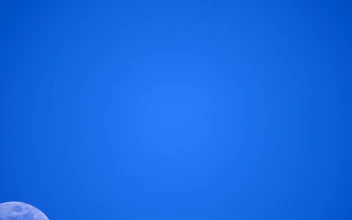 Stock Video Half Moon Crossing A Clear Blue Sky For PC