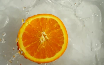 Stock Video Half An Orange Floating And Spinning In Water For PC