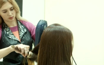 Stock Video Hairstylist Drying The Hair Of The Client For PC