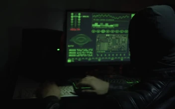 Stock Video Hacker With Balaclava Working In Front Of A Computer For PC