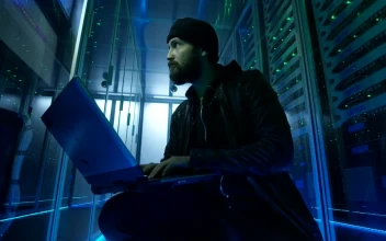 Stock Video Hacker Sitting On The Ground Of Data Center For PC