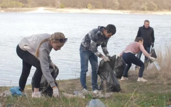 Stock Video Group Of Volunteers Cleaning Up Trash Near A River For PC