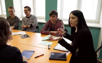 Stock Video Group Of Students Sitting With A Teacher For PC