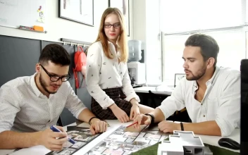 Stock Video Group Of Architects Discussing A Building Model For PC