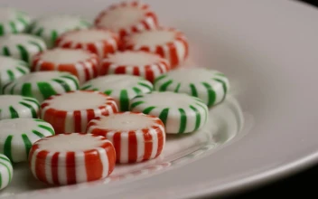 Stock Video Green And Red Candies Rotating On A White Plate For PC