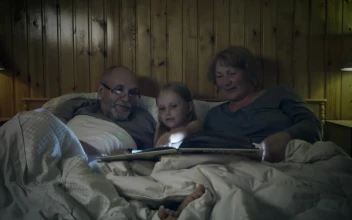 Stock Video Grandparents Reading A Story To Their Grandchild For PC