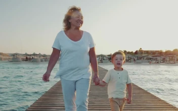 Stock Video Grandmother Walking Along A Pier For PC