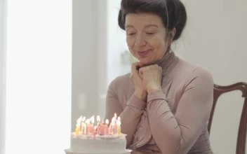Stock Video Grandmother On Her Birthday With A Cake With Candles For PC