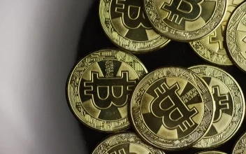 Stock Video Golden Bitcoins Rotating On A Black Plate For PC